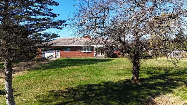 a aerial view of a house with a yard and lake view