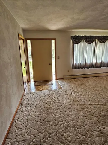 a view of room with window and wooden floor