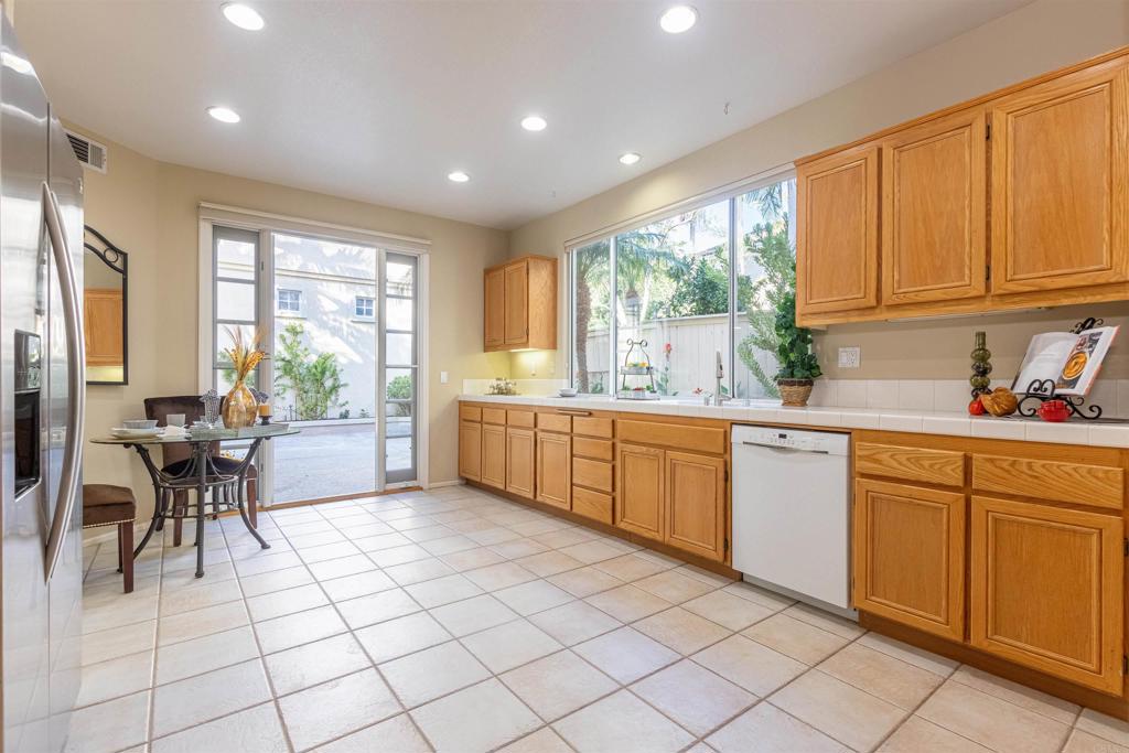 7189 Tanager Drive Carlsbad, CA 92011 - Photo 13 of 31 a kitchen with a sink window and cabinets