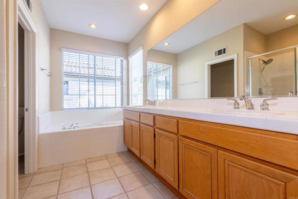 7189 Tanager Drive Carlsbad, CA 92011 - Photo 19 of 31 a spacious bathroom with a large tub sink and mirror