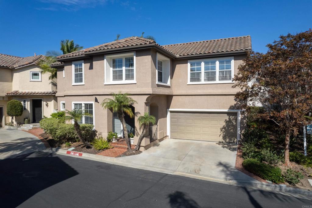 7189 Tanager Drive Carlsbad, CA 92011 - Photo 24 of 31 a front view of a house with a yard and garage