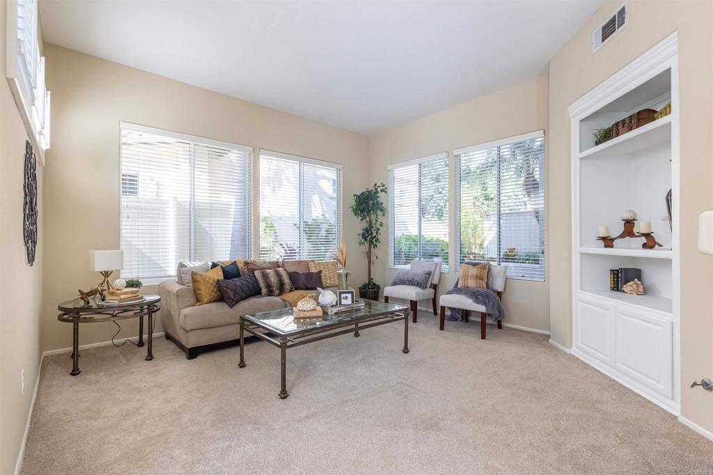 7189 Tanager Drive Carlsbad, CA 92011 - Photo 7 of 31 a living room with furniture and large windows