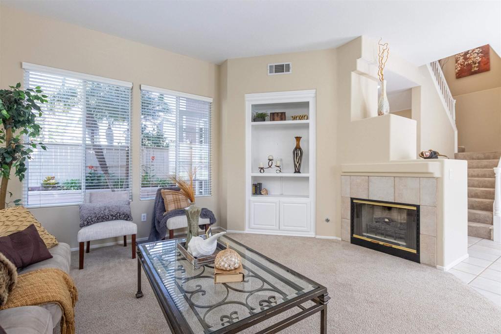 7189 Tanager Drive Carlsbad, CA 92011 - Photo 8 of 31 a living room with furniture and a fireplace