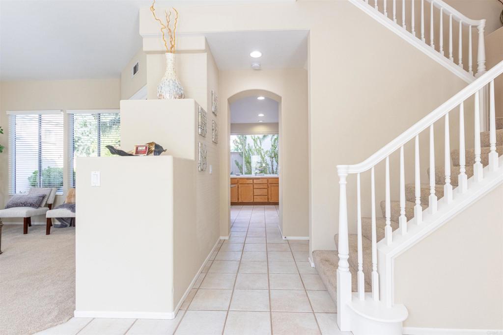7189 Tanager Drive Carlsbad, CA 92011 - Photo 9 of 31 a view of hallway with furniture and a chandelier