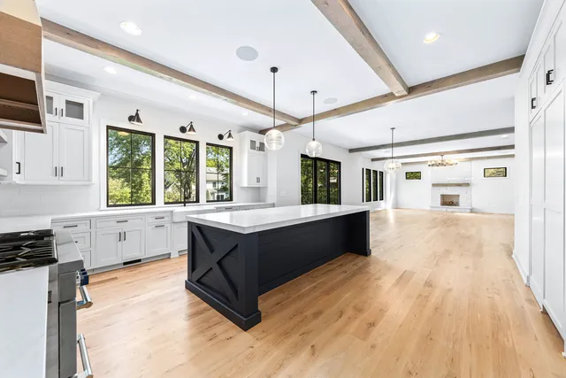 a large kitchen with granite countertop a large counter top and sink