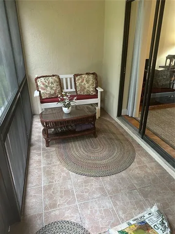 a backyard of a house with trees and outdoor seating