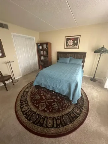 a bed room with a bed and chair