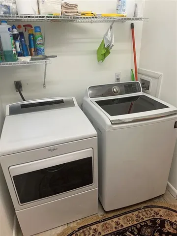 a view of dining table chairs and chandelier