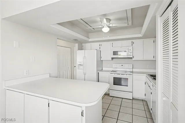 a kitchen with stainless steel appliances a stove refrigerator sink and cabinets