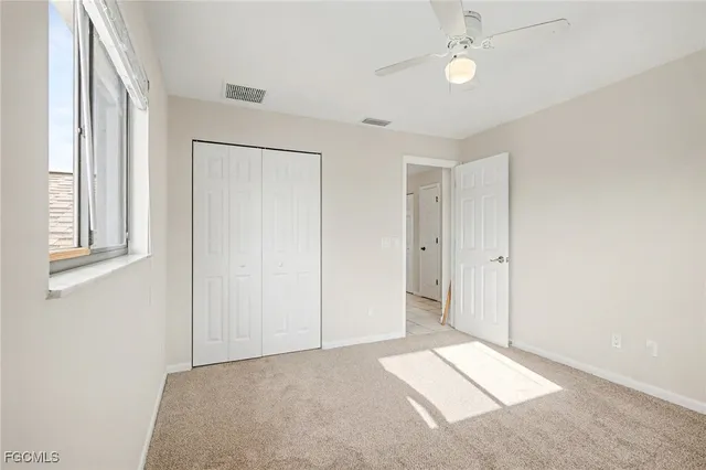 a view of livingroom with an empty space & a ceiling fan