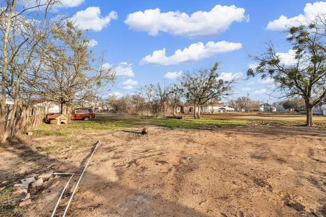 a view of a yard with large trees