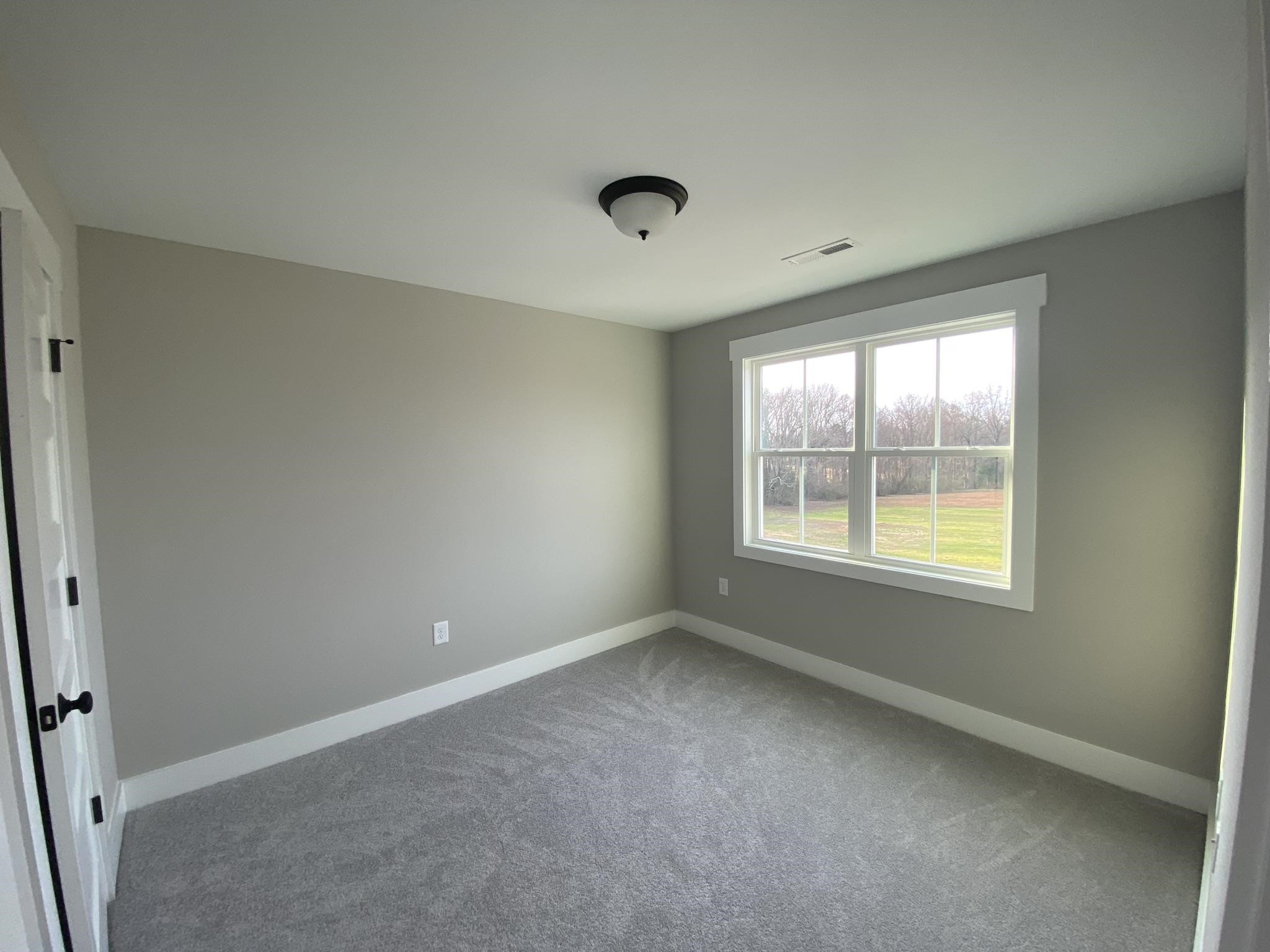 75 Buckstone Place Willow Spring, NC 27592 - Photo 19 of 32 an empty room with a window