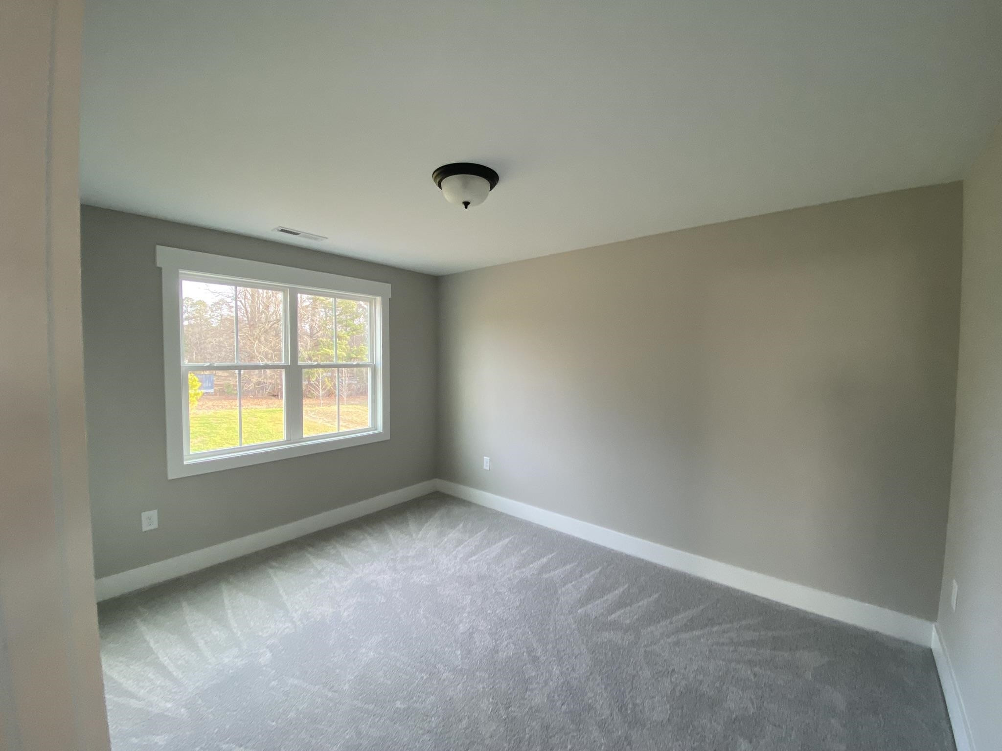 75 Buckstone Place Willow Spring, NC 27592 - Photo 20 of 32 an empty room with a window