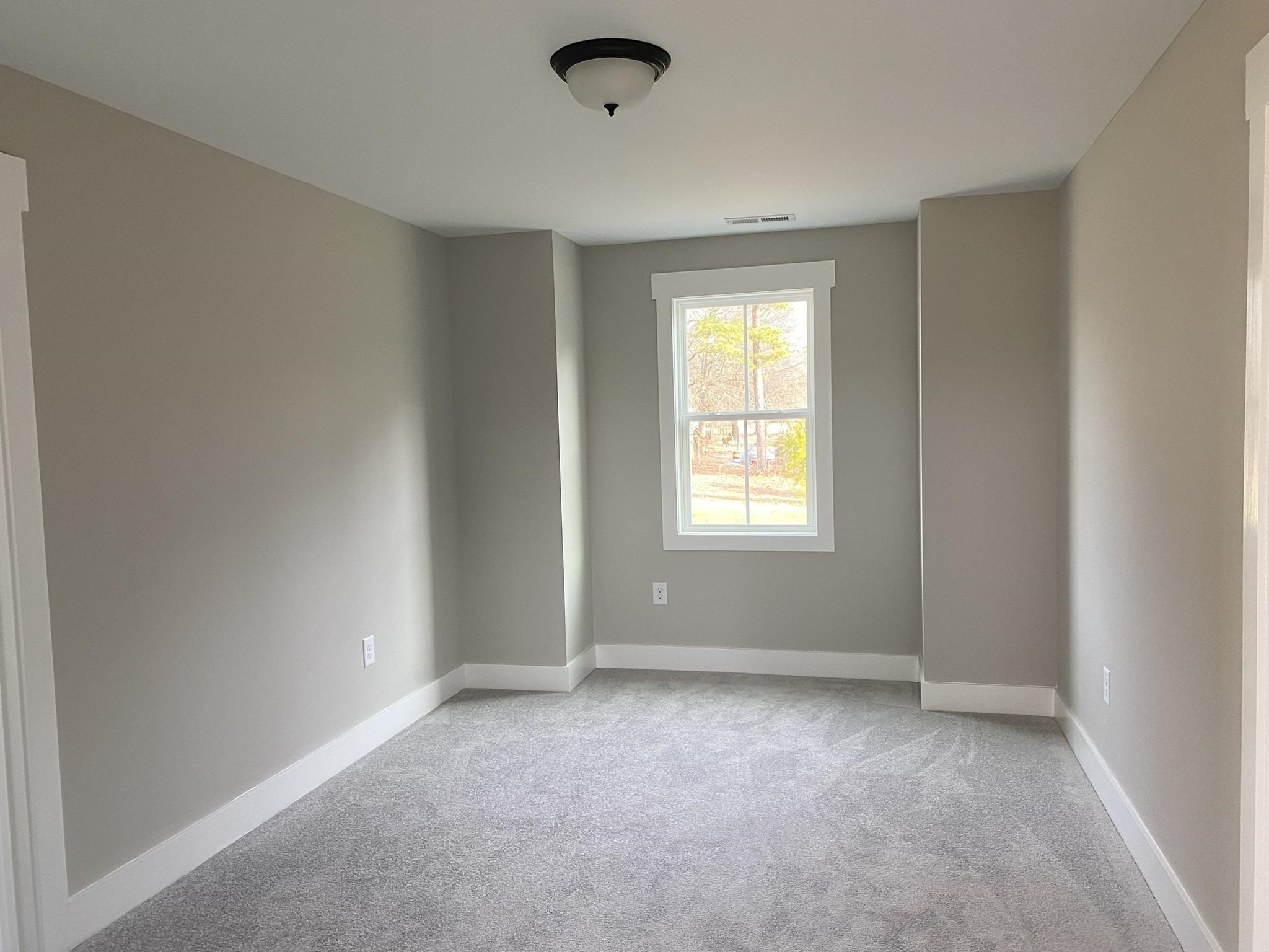 75 Buckstone Place Willow Spring, NC 27592 - Photo 21 of 32 an empty room with windows