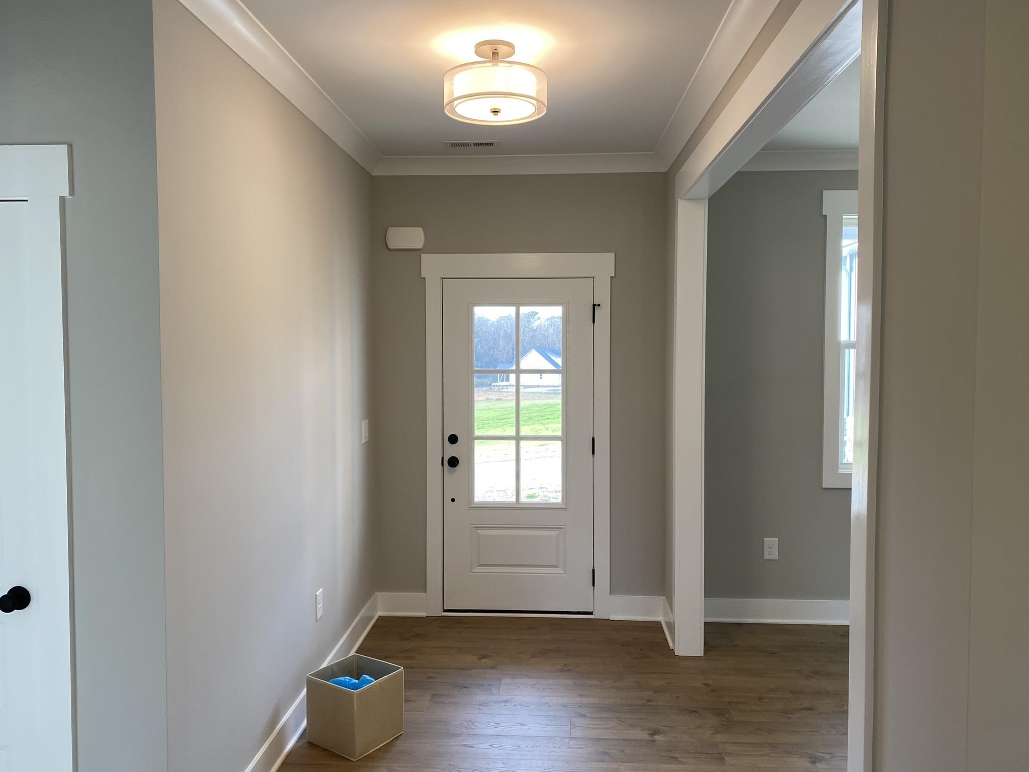 75 Buckstone Place Willow Spring, NC 27592 - Photo 3 of 32 a view of an empty room with wooden floor and a window
