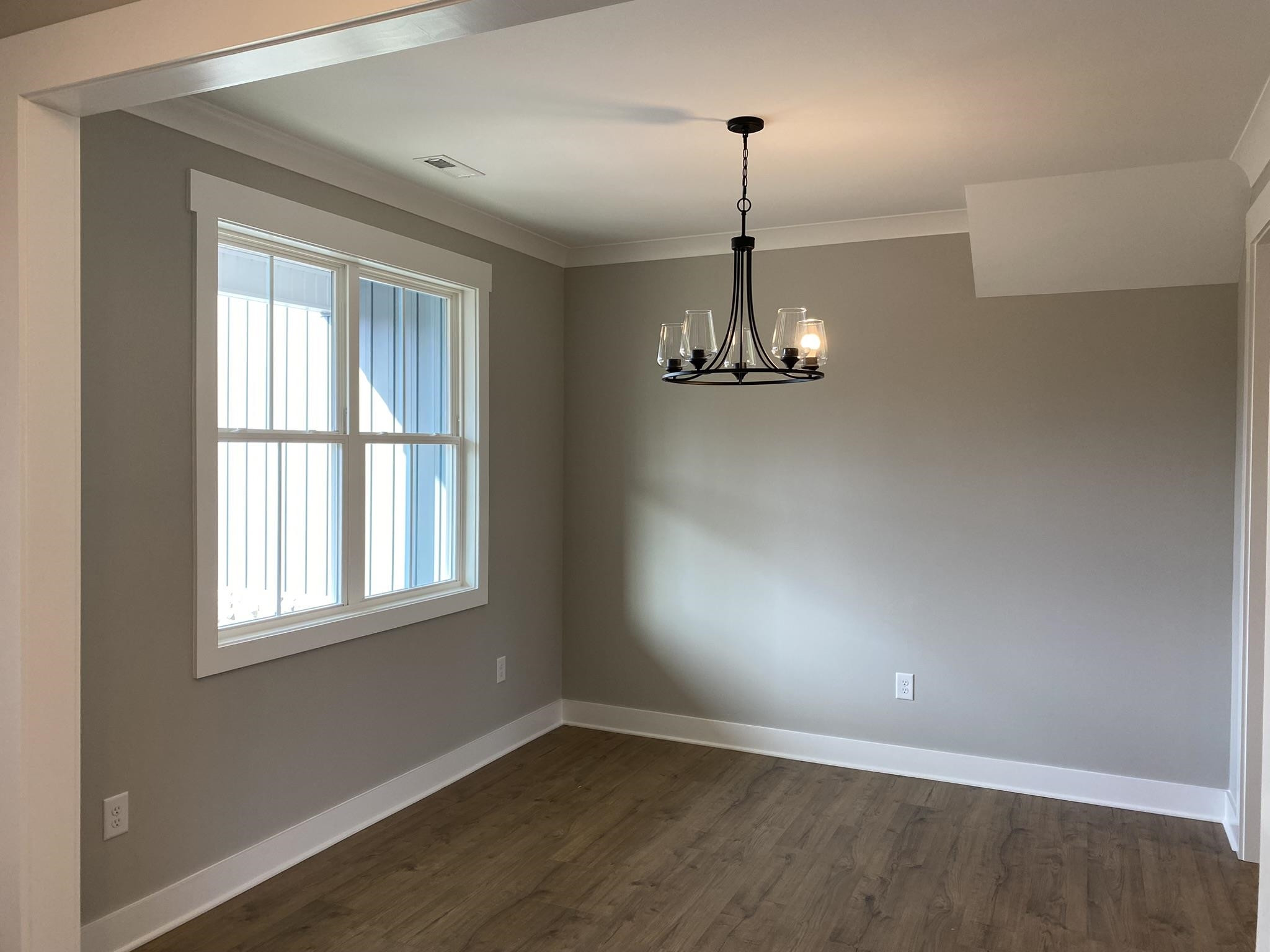 75 Buckstone Place Willow Spring, NC 27592 - Photo 4 of 32 a view of empty room with wooden floor and window