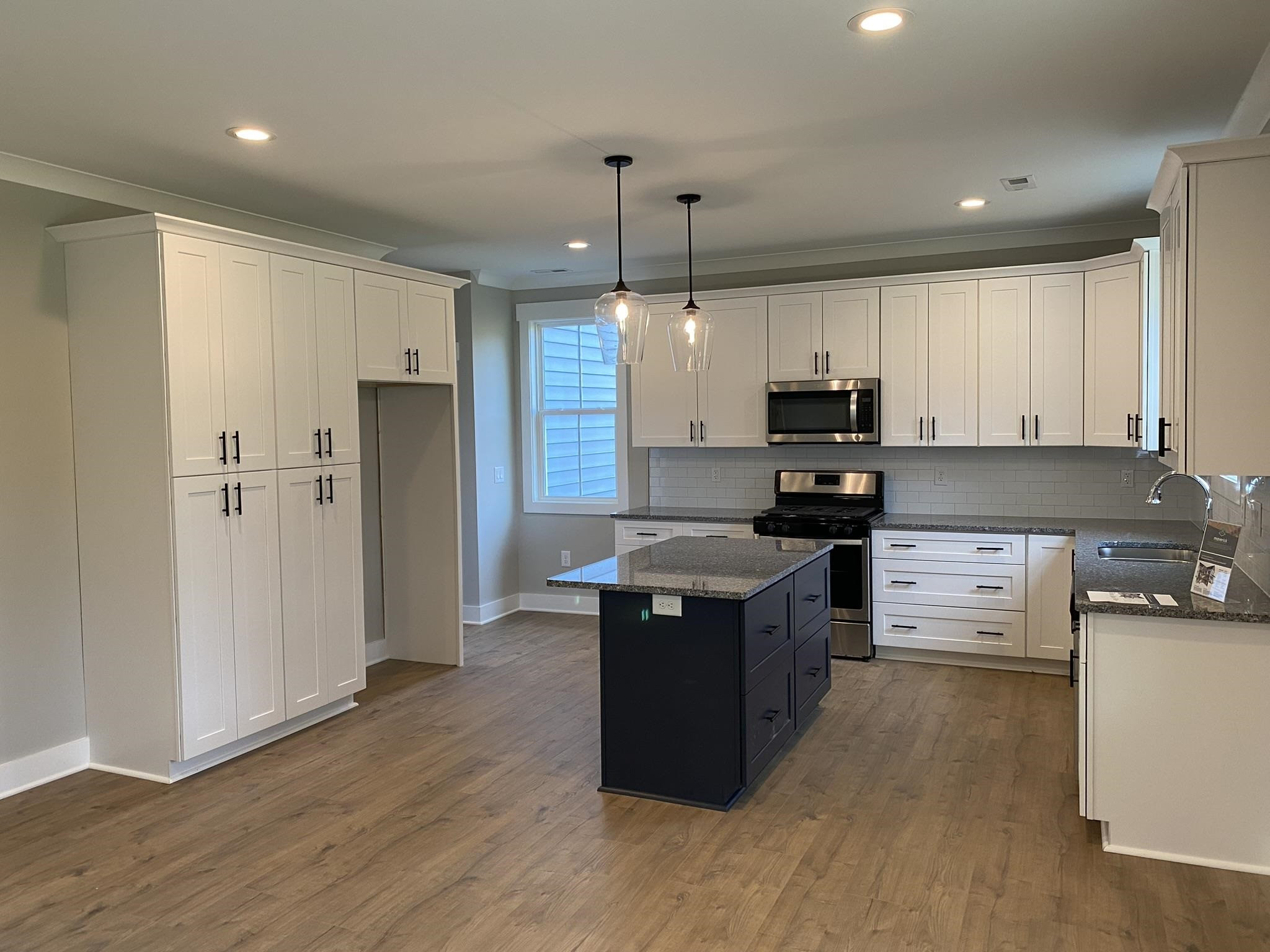 75 Buckstone Place Willow Spring, NC 27592 - Photo 6 of 32 a kitchen with stainless steel appliances granite countertop a refrigerator a stove top oven a sink and dishwasher with wooden floor