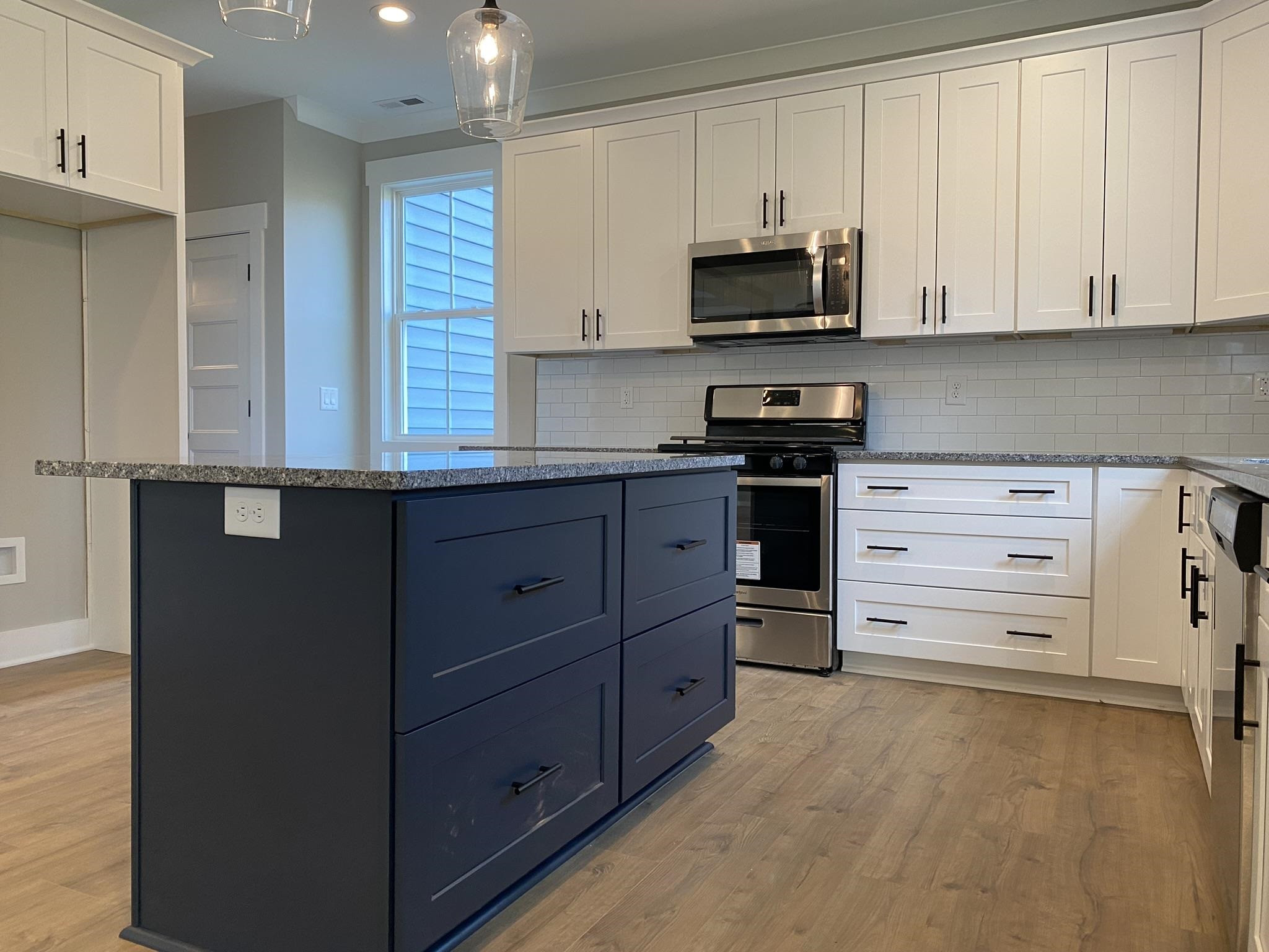 75 Buckstone Place Willow Spring, NC 27592 - Photo 7 of 32 a kitchen with stainless steel appliances a stove and a microwave