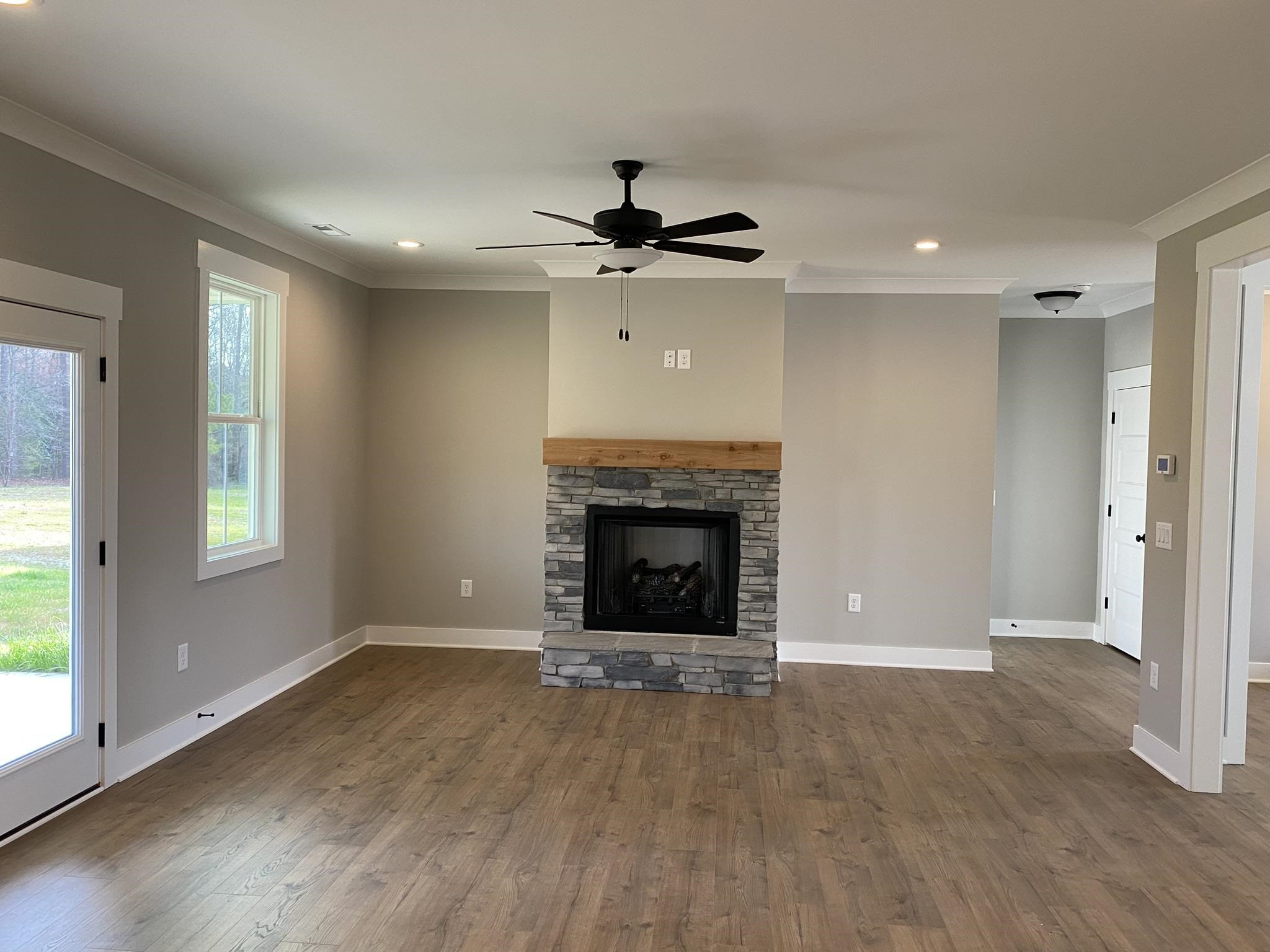 75 Buckstone Place Willow Spring, NC 27592 - Photo 9 of 32 an empty room with windows and a fireplace