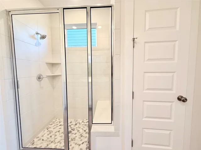 a spacious bathroom with a double vanity sink and mirror