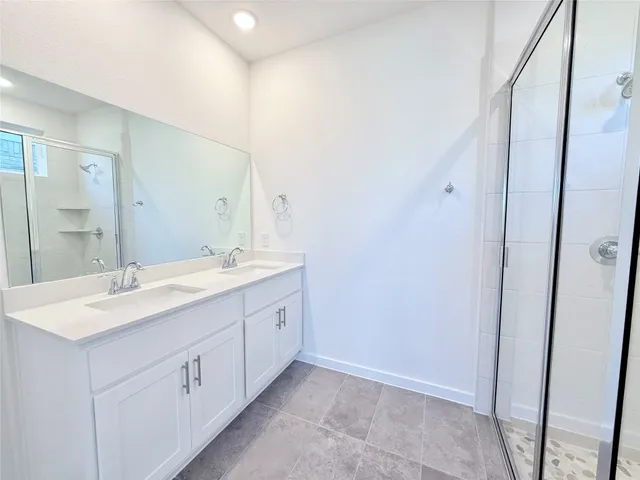a bathroom with a glass shower door