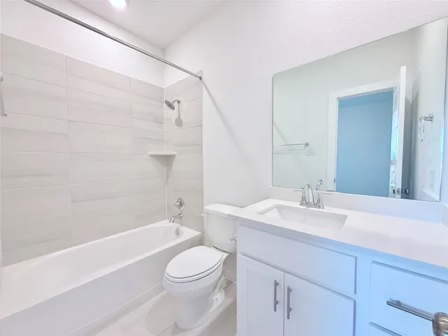 an empty room with closet and a ceiling fan