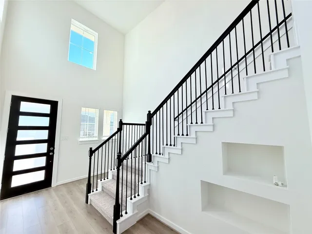 a view of staircase with wooden floor and a window