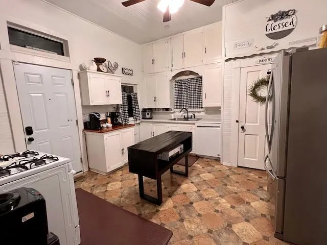 a kitchen with stainless steel appliances a stove a refrigerator and a sink