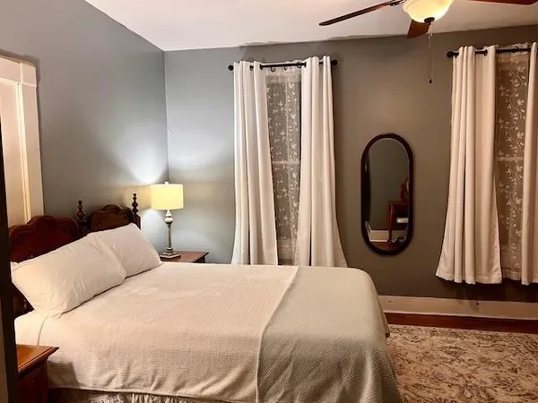 a bedroom with a bed and a mirror
