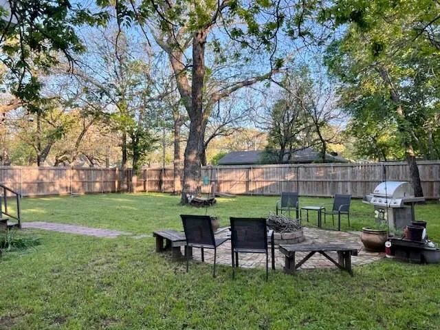 a view of a table and chairs in the garden