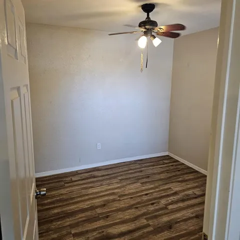 a view of a room with a fan and a window