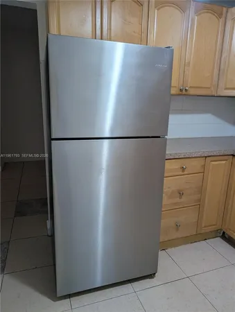 a view of a kitchen with refrigerator