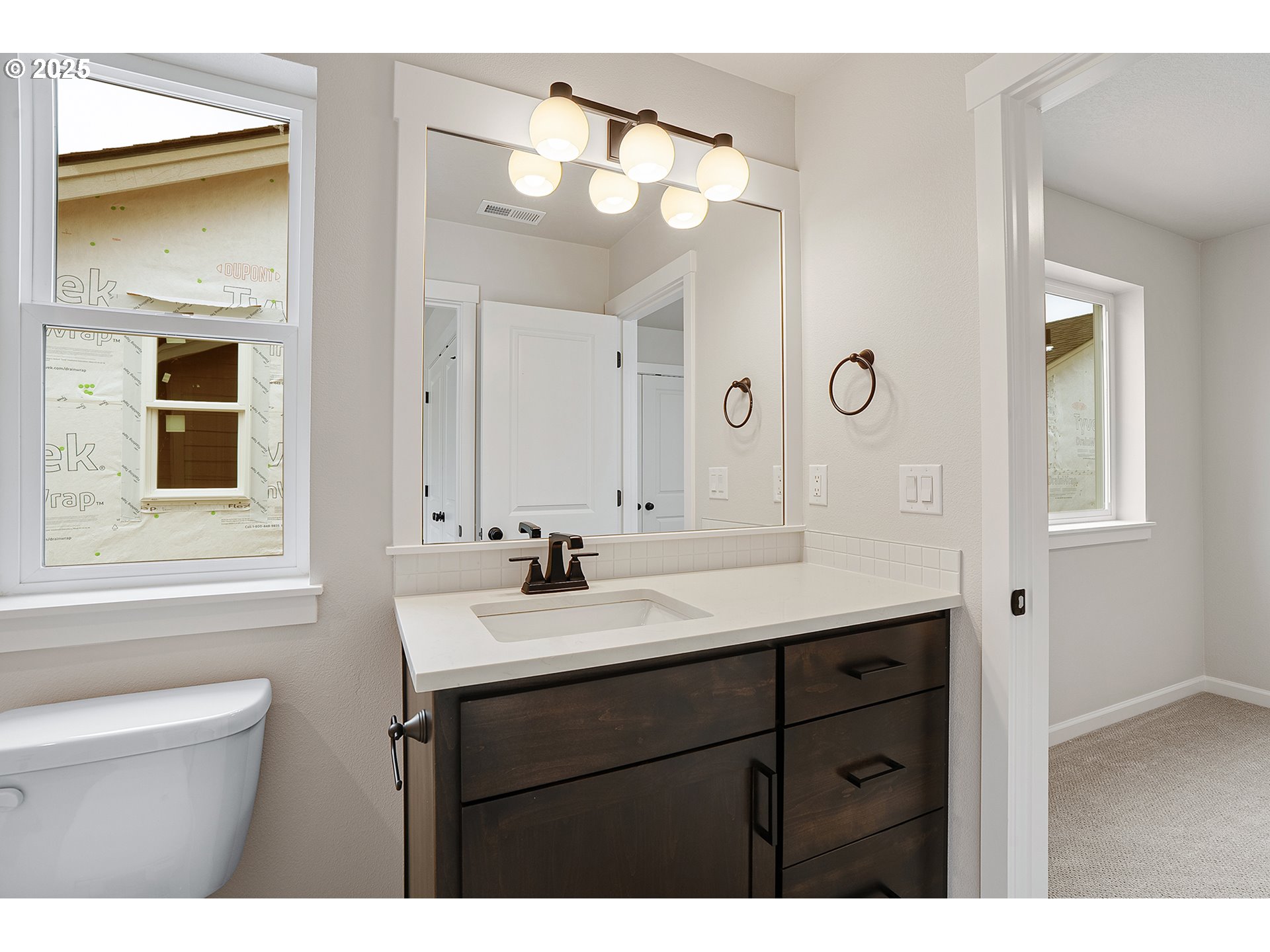 4652 Southeast 2nd Street Gresham, OR 97080 - Photo 25 of 30 a bathroom with a sink a mirror a vanity and a toilet