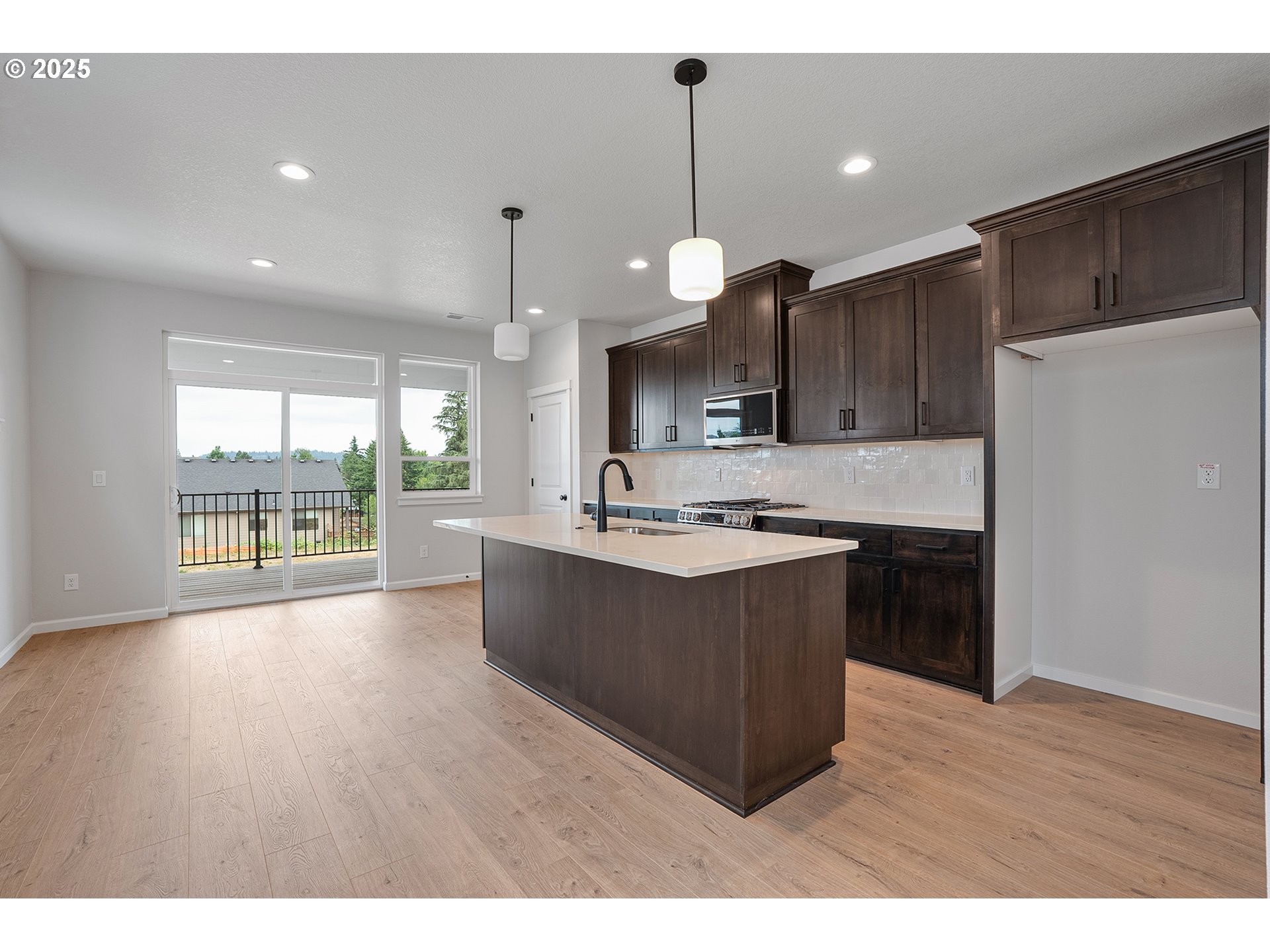 4652 Southeast 2nd Street Gresham, OR 97080 - Photo 8 of 30 a large kitchen with kitchen island a sink stainless steel appliances and cabinets