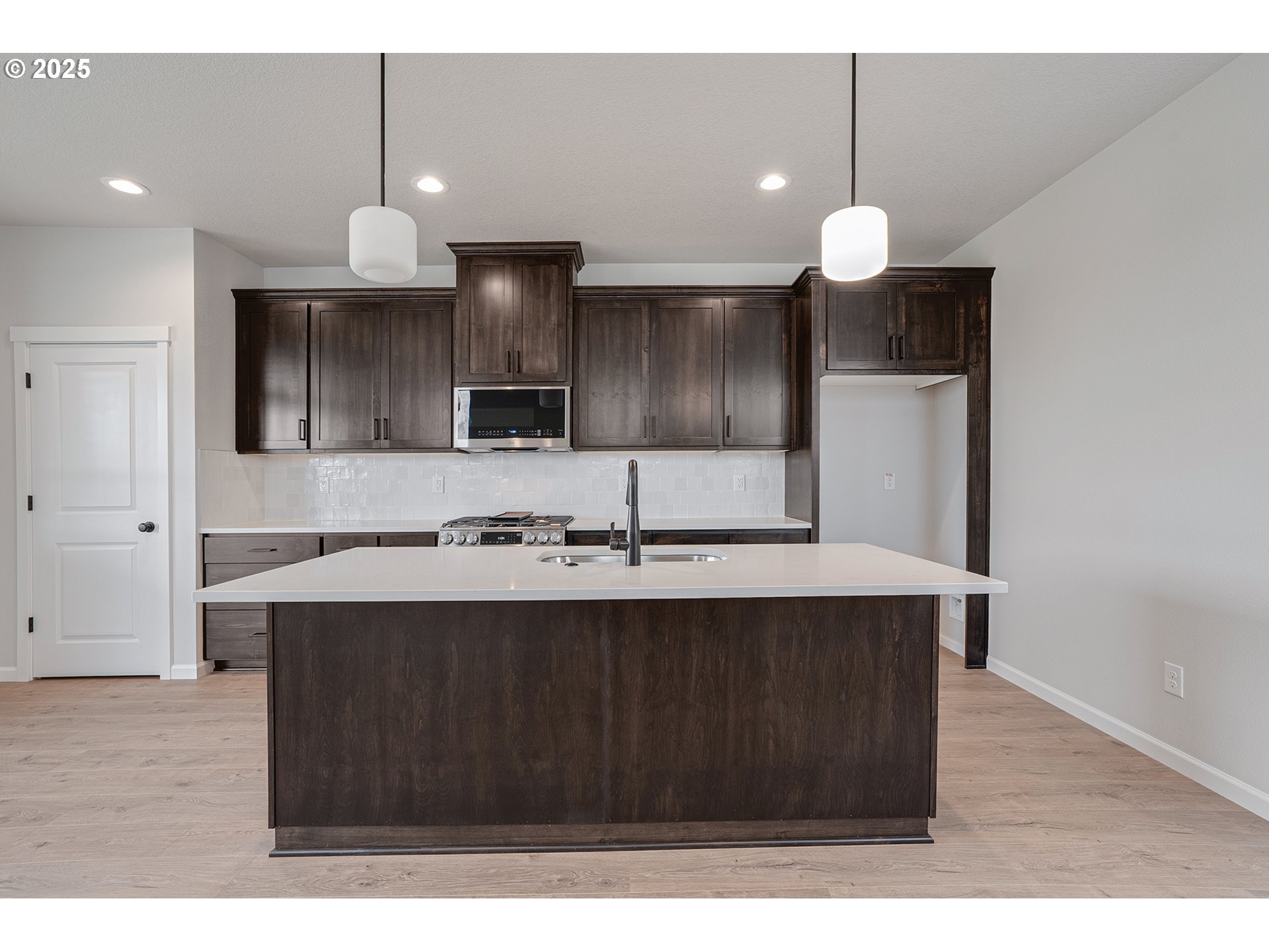 4652 Southeast 2nd Street Gresham, OR 97080 - Photo 9 of 30 a kitchen with kitchen island a sink stainless steel appliances and cabinets