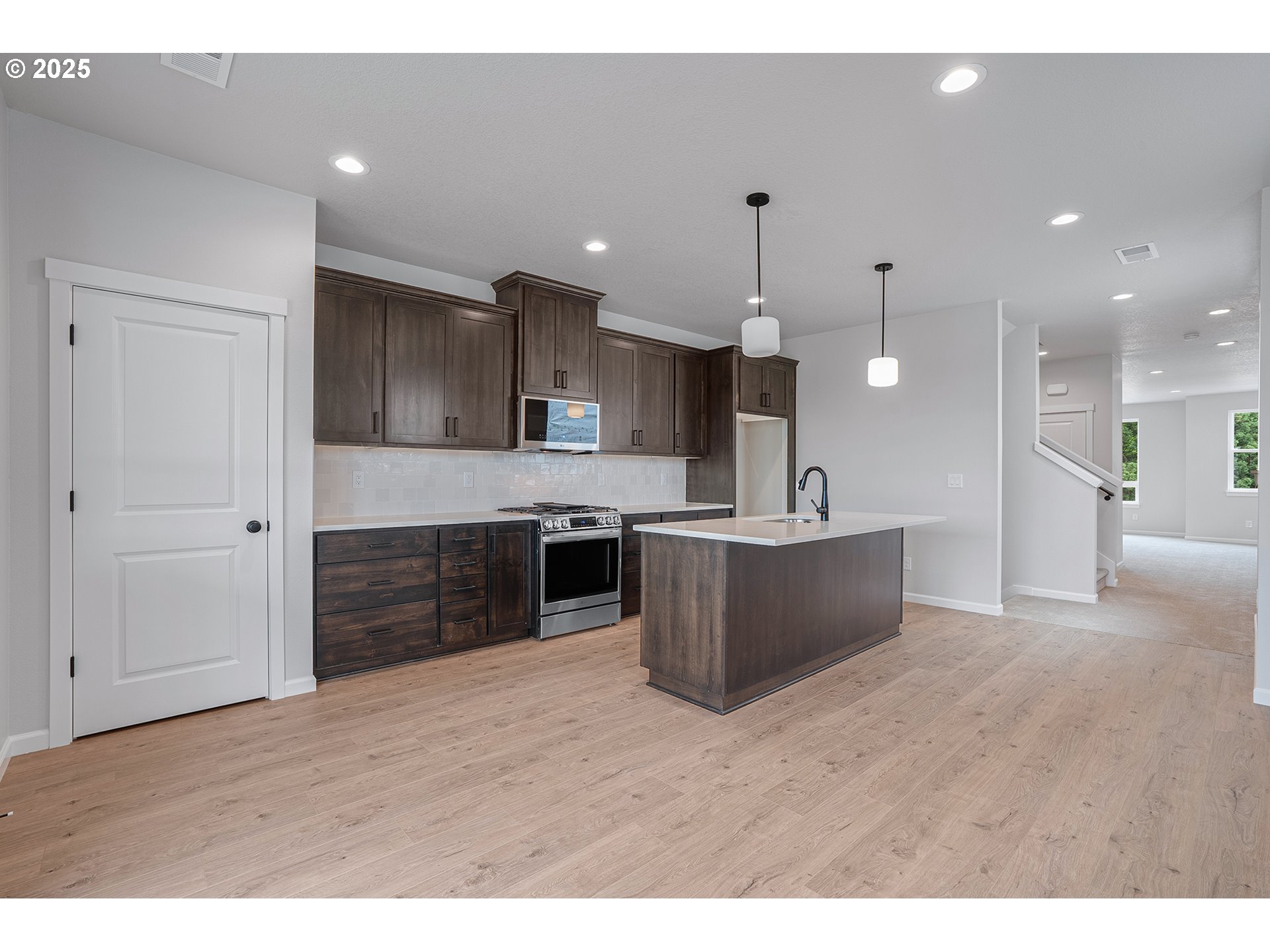4652 Southeast 2nd Street Gresham, OR 97080 - Photo 10 of 30 a kitchen with kitchen island a sink stainless steel appliances and cabinets