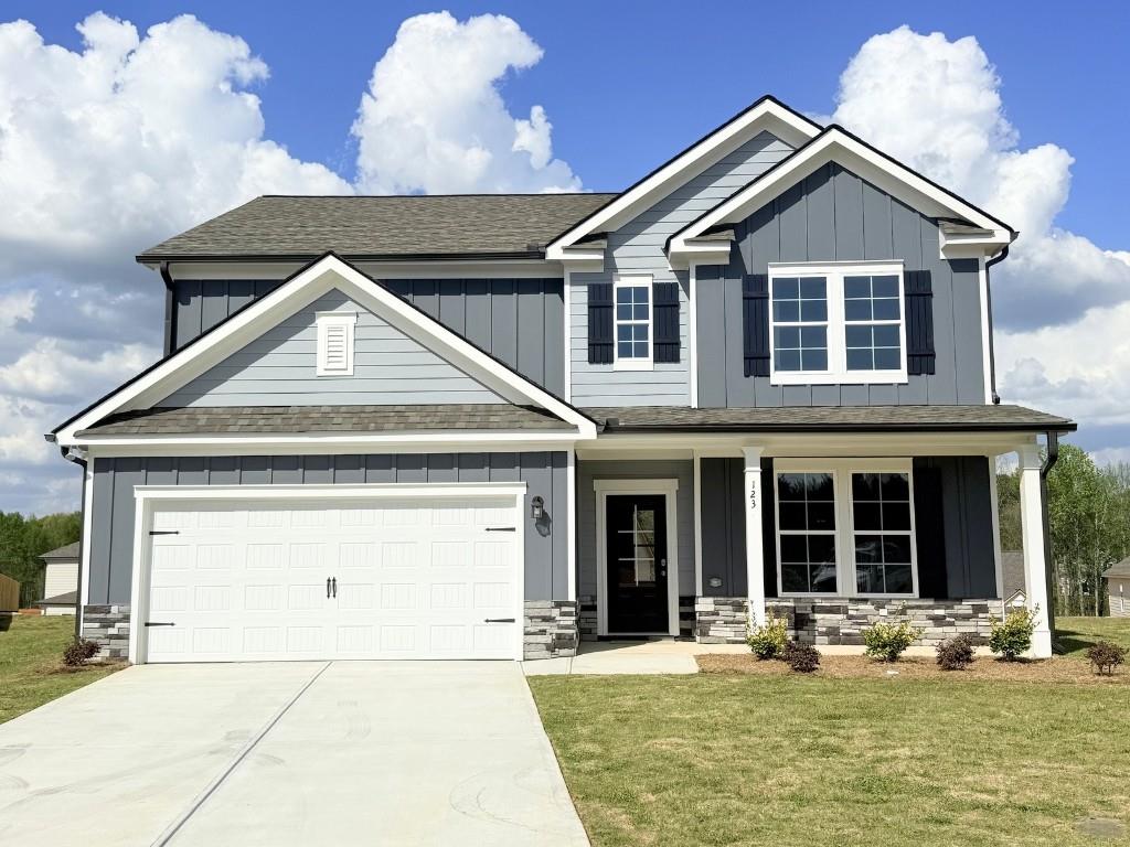 123 Purackal Lane Statham, GA 30666 - Photo 1 of 49 a front view of a house with a yard and garage