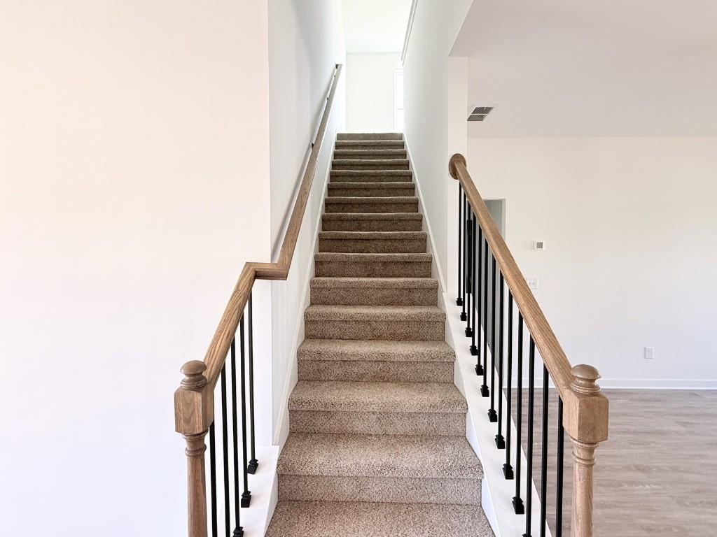 123 Purackal Lane Statham, GA 30666 - Photo 13 of 49 a view of staircase with wooden floor and white walls