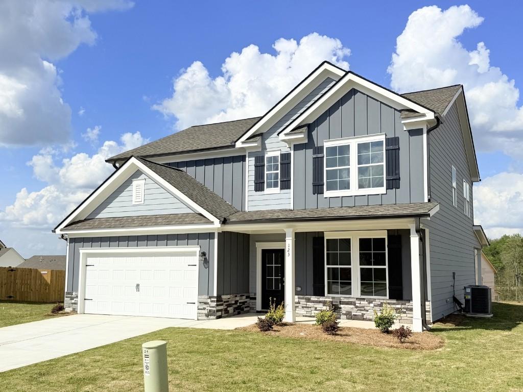 123 Purackal Lane Statham, GA 30666 - Photo 2 of 49 a front view of a house with a yard