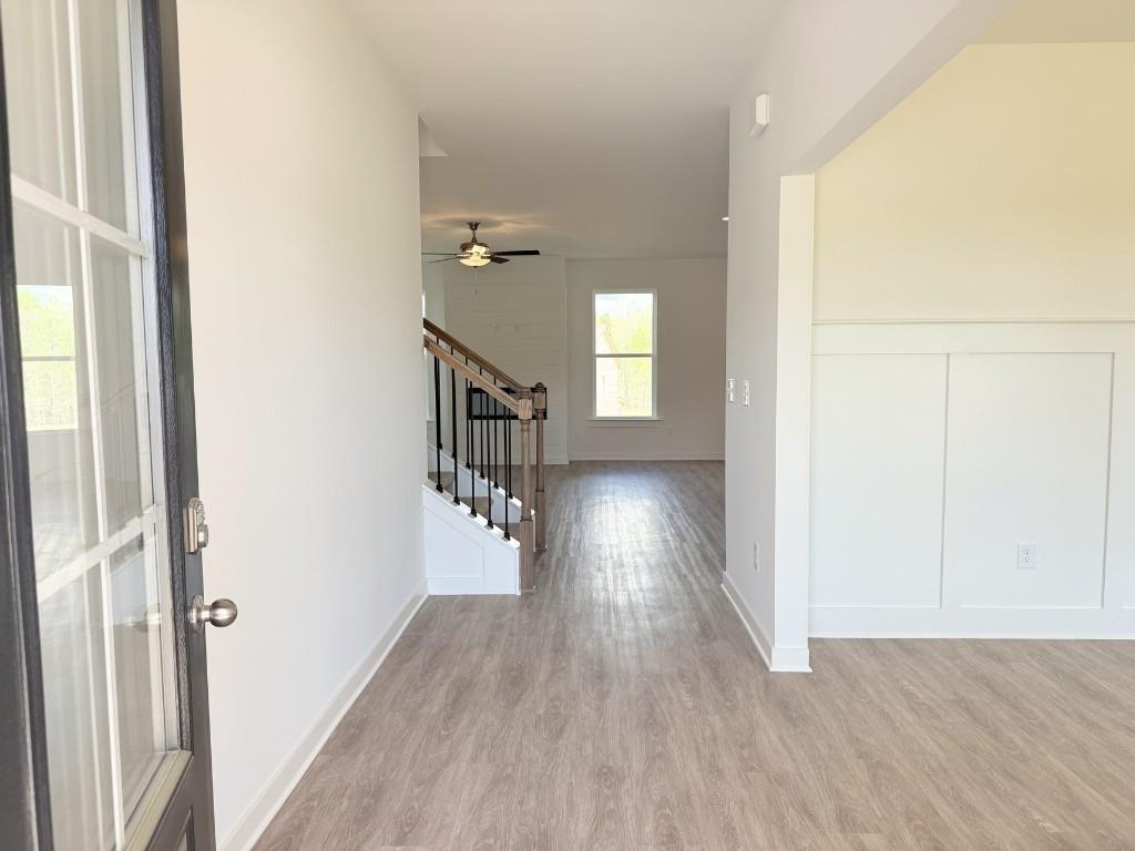 123 Purackal Lane Statham, GA 30666 - Photo 4 of 49 a view of a room with wooden floor staircase and a living room