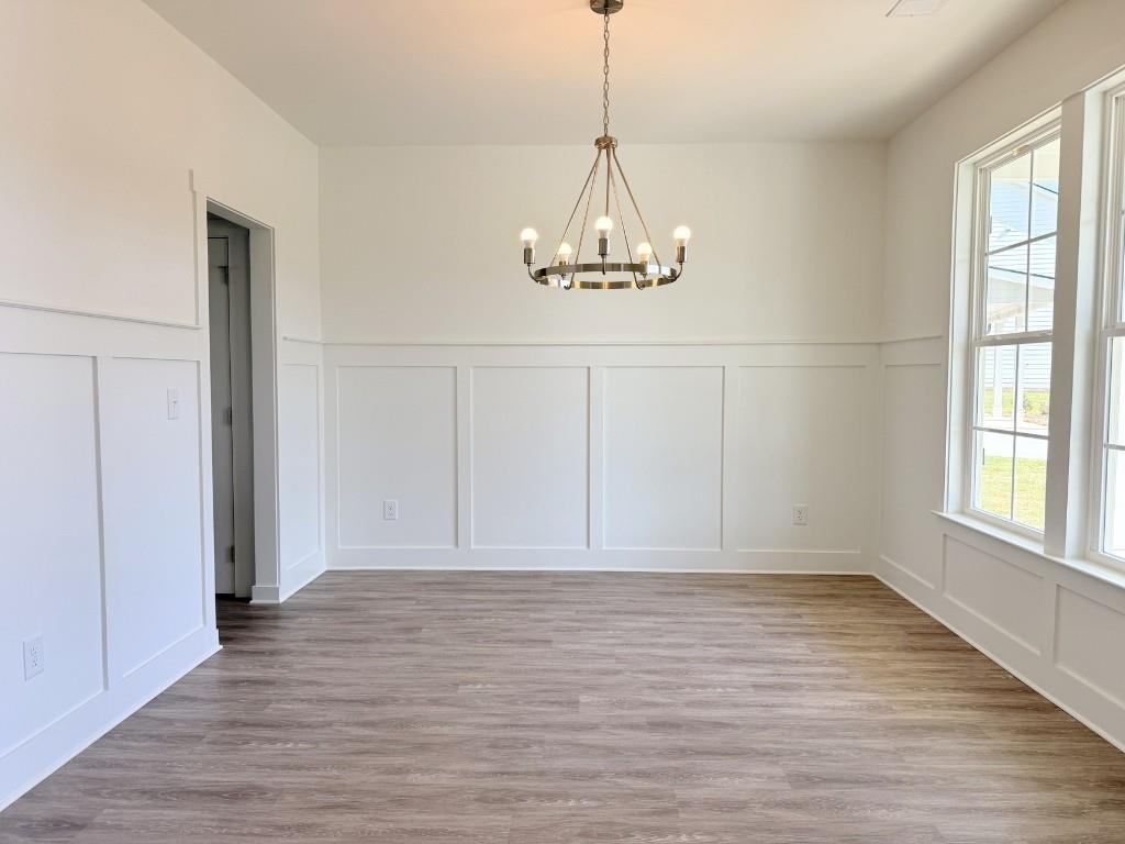 123 Purackal Lane Statham, GA 30666 - Photo 5 of 49 a view of empty room with wooden floor and window
