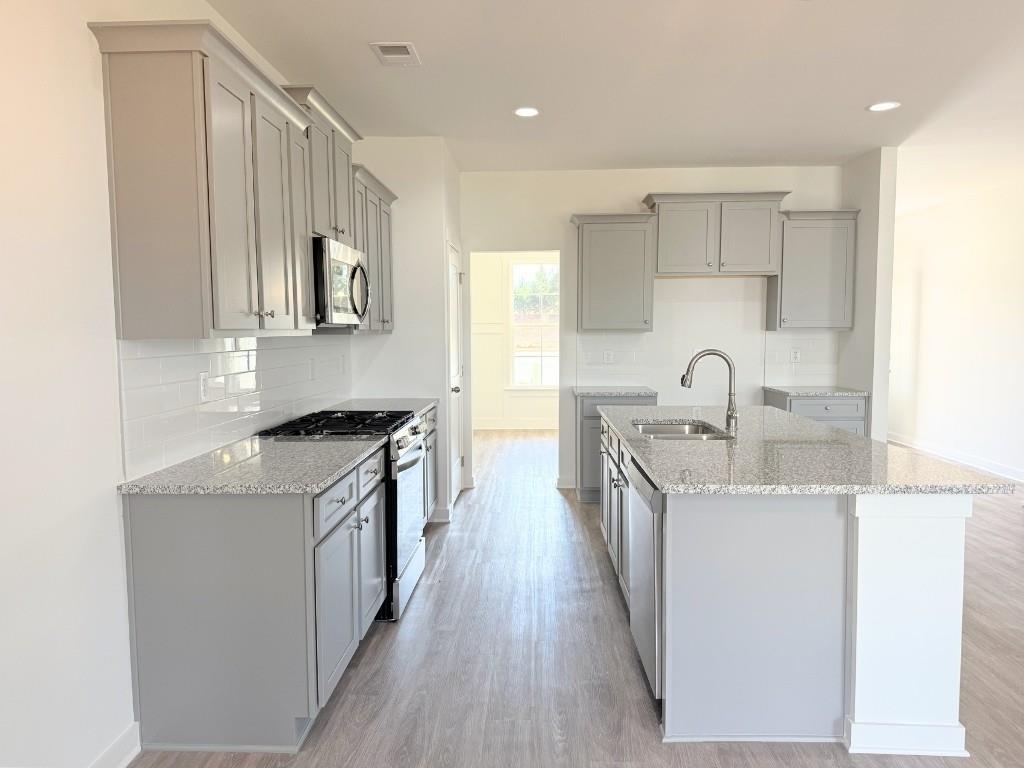 123 Purackal Lane Statham, GA 30666 - Photo 8 of 49 a kitchen with stainless steel appliances granite countertop a sink stove and refrigerator