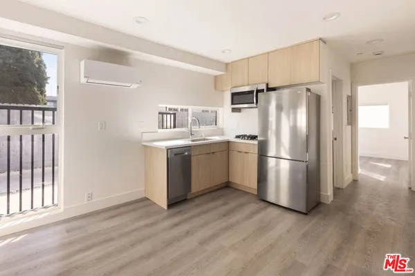 a kitchen with stainless steel appliances a refrigerator and a stove