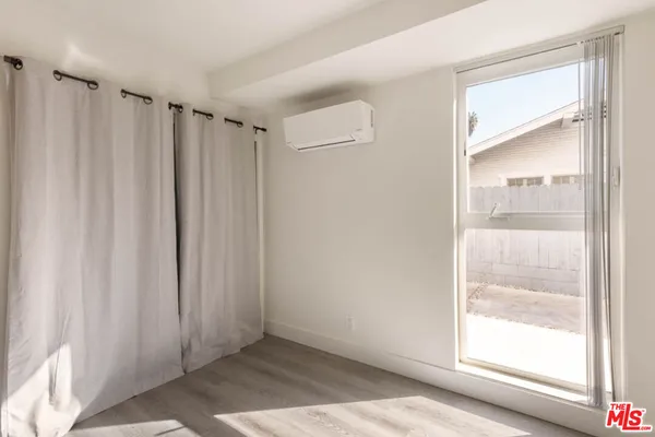 a room with a cabinet and a microwave