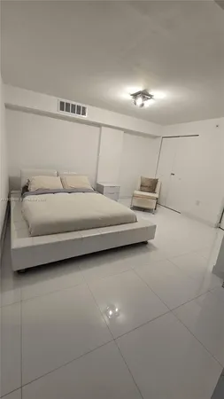 a bedroom with bed and window