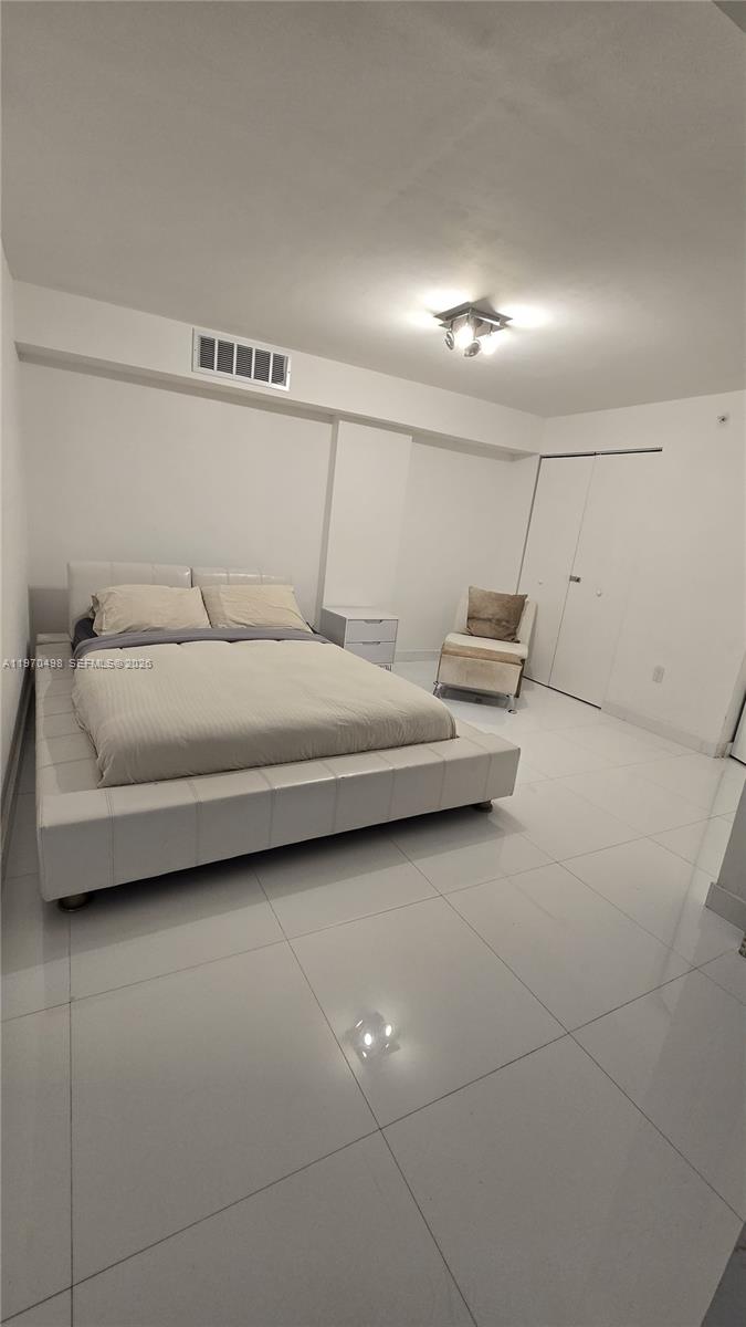 9195 Collins Avenue, Unit 406 Surfside, FL 33154 - Photo 2 of 12 a bedroom with bed and window
