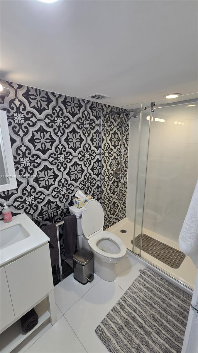 9195 Collins Avenue, Unit 406 Surfside, FL 33154 - Photo 6 of 12 a bathroom with a toilet and a shower