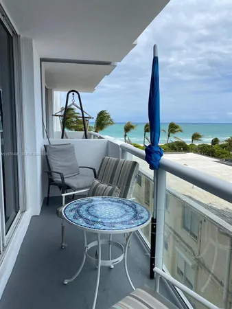 a view of balcony with outdoor seating and city view