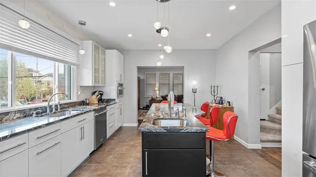 a kitchen with stainless steel appliances granite countertop a sink and cabinets