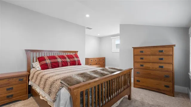 a bedroom with a bed and a dresser